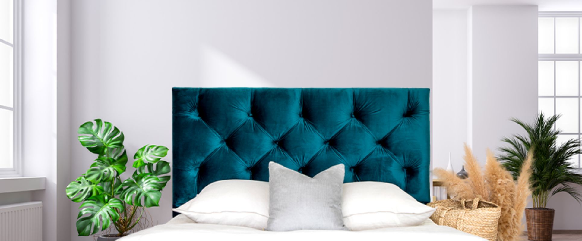 Teal coloured headboard behind a bed